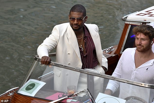 He accessorized with gold necklaces including one with a massive pendant of his logo as he also sported a pair of gold-rimmed aviator shades