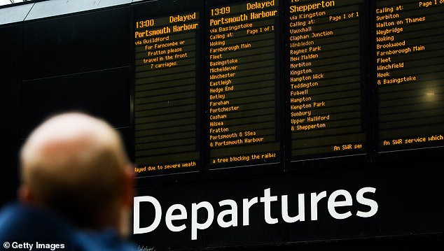 Delayed and cancelled train information is shown on screen at Waterloo Station due to Storm Darragh on December 7, 2024 in London