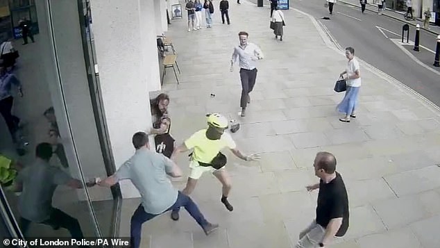 Spencer Duarte (in yellow) being tackled by members of the public after snatching a phone