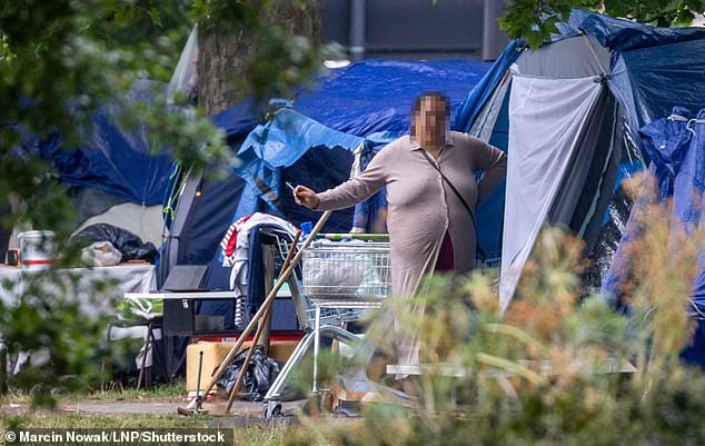 A migrant camps outside tents on Park Lane in central London, an area known as Billionaires' Row