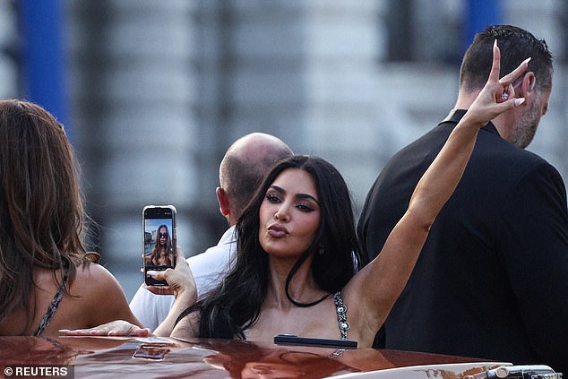 Kardashian poses for a photo while on a boat in Venice