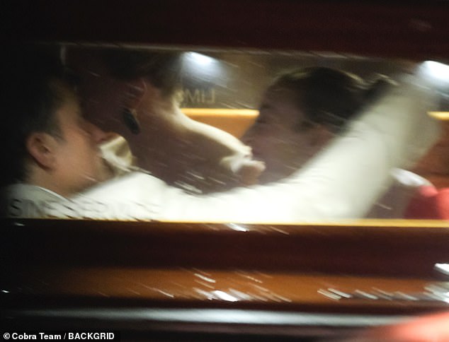 Once inside the boat, Bloom was caught wrapping his arm around the brunette