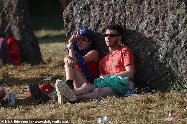 Glastonbury festivalgoers enjoy the sunshine this morning at Worthy Farm in Somerset