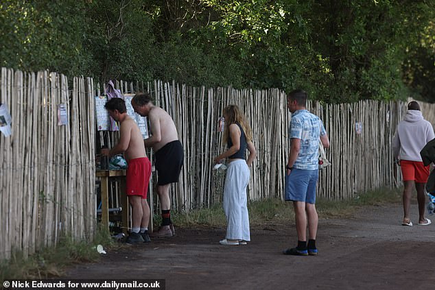 Glastonbury Festival revellers have a morning wash today at the site in Pilton, Somerset
