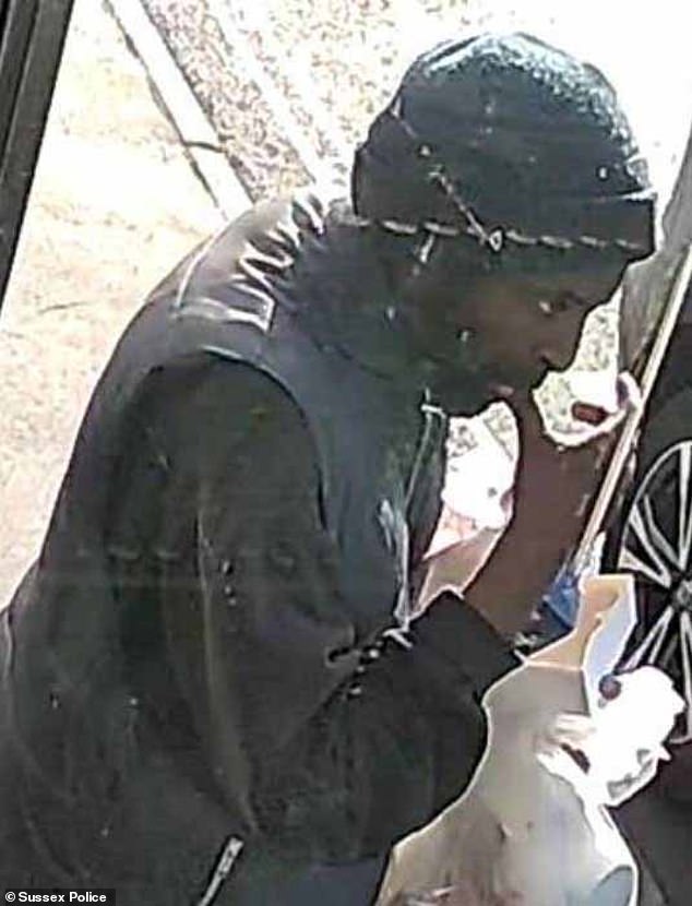 He is described as wearing a dark coloured gilet style puffer jacket, black jumper, black tracksuit bottoms and a beanie hat