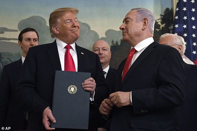 President Donald Trump smiles at Israeli Prime Minister Benjamin Netanyahu, right
