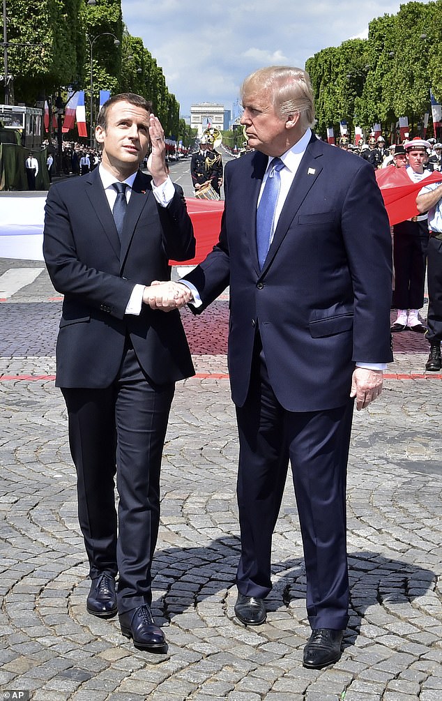 French President Emmanuel Macron, left, shakes hands with U.S President Donald Trump after the Bastille Day military parade on the Champs Elysees avenue in Paris Friday, July 14, 2017