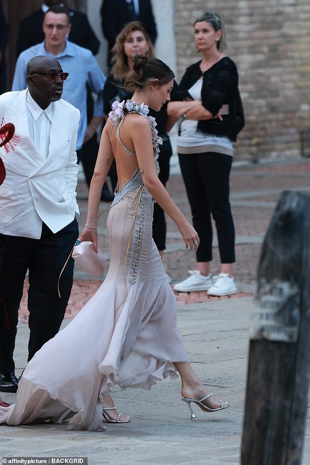 The supermodel, 27, looked incredible as she waltzed through the Italian streets in a backless gown with ruffled detailing as she attended the engaged couple's pre-wedding dinner
