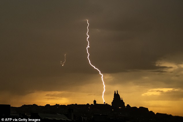 FRANCE: Photograph shows a lightning bolt falling near Sacre Coeur Basilica in Montmartre during a thunderstorm