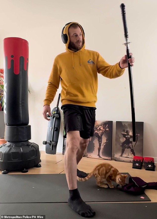 Monzo filmed himself unwrapping the sword he later used to kill Daniel Anjorin. Also in this image is his cat, Wizard, who he strangled, skinned and de-boned because he became convinced the pet would be the architect of Armageddon