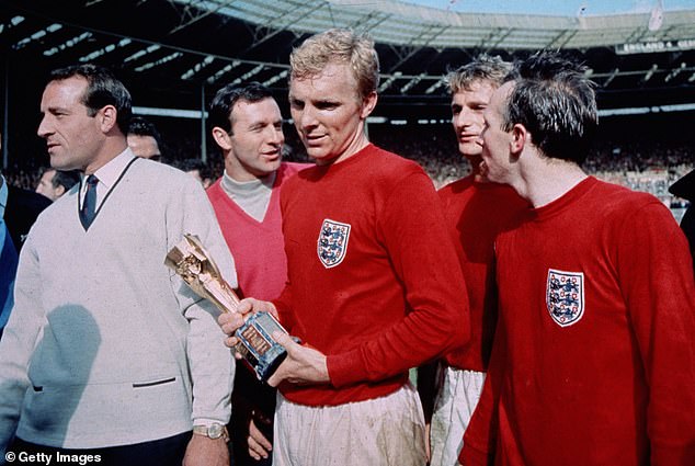 Moore is pictured holding the hallowed Jules Rimet trophy after the 1966 World Cup final