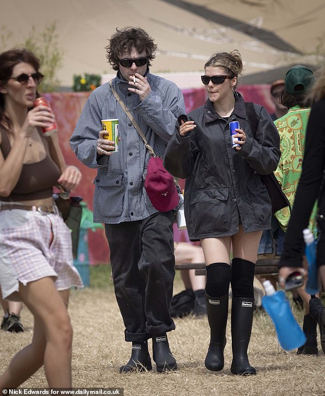 Lennon was seen puffing away on a cigarette as he made his way through the field