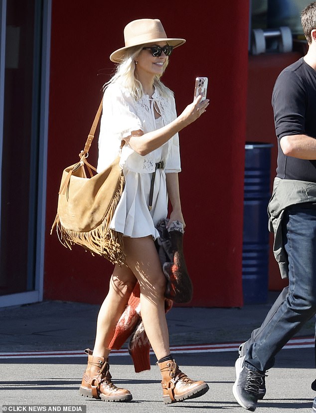 She teamed her boho chic look with a matching cardigan with frilled sleeves and kept comfortable in a pair of brown lace-up boots