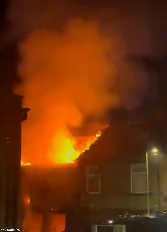 Pictured: the aftermath of the explosion which caused a huge fire with flames and smoke erupting into the sky