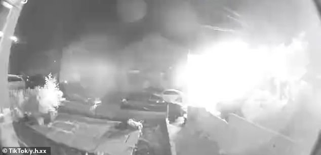 Up to 14 homes were evacuated due to the explosion (pictured) that appeared to rip off the roof of at least one home, sending debris flying into the streets