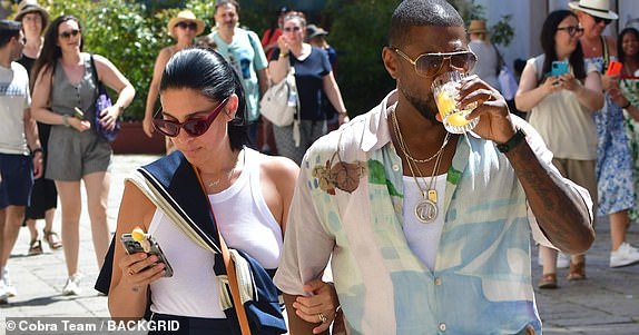 BGUK_3284331 - Venice, ITALY  Usher and Jennifer Goicoechea are spotted strolling around Venice, enjoying a drink together. Both dressed in effortless, European summer looks, the couple take in the sights of the iconic city while keeping things casual.  Pictured: Usher,Jennifer Goicoechea  BACKGRID UK 27 JUNE 2025   BYLINE MUST READ: COBRA TEAM / BACKGRID  UK: +44 208 344 2007 / uksales@backgrid.com  USA: +1 310 798 9111 / usasales@backgrid.com  *Pictures Containing Children Please Pixelate Face Prior To Publication*