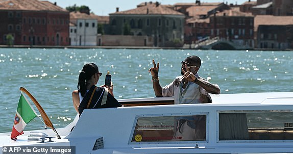US singer Usher Raymond IV and wife Jennifer Goicoechea are pictured on a taxi boat in Venice lagoon ahead of US Amazon founder Jeff Bezos' wedding with Lauren Sanchez, on June 27, 2025.  (Photo by Stefano Rellandini / AFP) (Photo by STEFANO RELLANDINI/AFP via Getty Images)