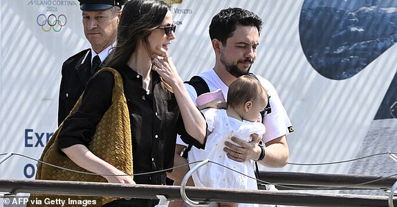Jordan's Princess Rajwa (L), Crown Prince of Jordan, Hussein bin Abdullah and their daughter Iman Bint Hussein board a taxi boat after landing at Venice Marco Polo airport ahead of Jeff Bezos' wedding on June 26, 2025. Celebrities in superyachts sail into Venice this week for the three-day wedding party of Amazon tycoon Jeff Bezos and Lauren Sanchez, despite irate locals who say the UNESCO city is no billionaire's playground. The tech magnate and journalist have reportedly invited about 200 guests to their multi-million dollar nuptials in the Italian city, which are expected to kick off on June 26 and end Saturday with a ceremony at a secret location. (Photo by ANDREA PATTARO / AFP) (Photo by ANDREA PATTARO/AFP via Getty Images)