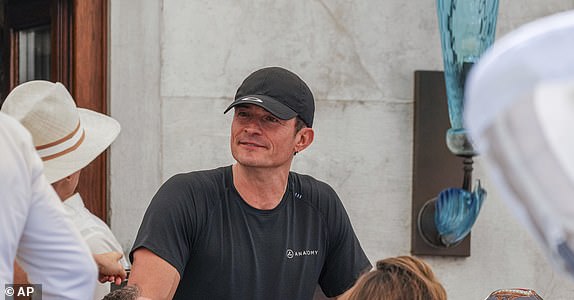 Orlando Bloom leaves his hotel, Friday, June 27, 2025 ahead of the anticipated wedding celebrations of Jeff Bezos and Lauren Sanchez. (AP Photo/Antonio Calanni)