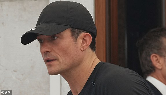 Orlando Bloom leaves his hotel, Friday, June 27, 2025 ahead of the anticipated wedding celebrations of Jeff Bezos and Lauren Sanchez. (AP Photo/Antonio Calanni)