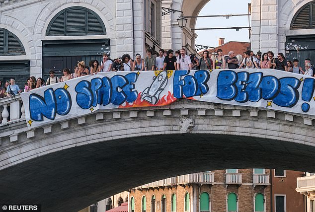 The business executive was one of the many celebrities who shrugged off raging protests by the Italian locals; a 'No Space For Bezos' sign is seen on the Rialto Bridge