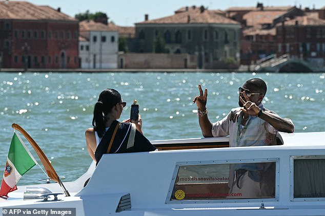 US singer Usher Raymond IV and wife Jennifer Goicoechea are pictured on a taxi boat in Venice lagoon
