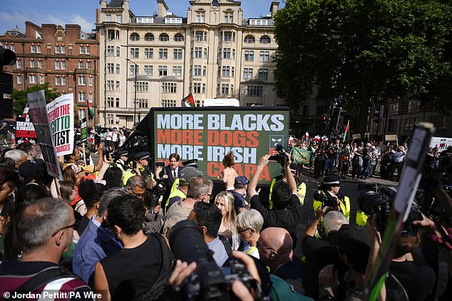 Police officers are seen among supporters of Kneecap's Liam Og O Hannaidh at court on June 18