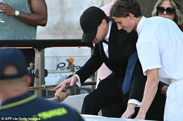 The superstar was helped onto a boat during the day