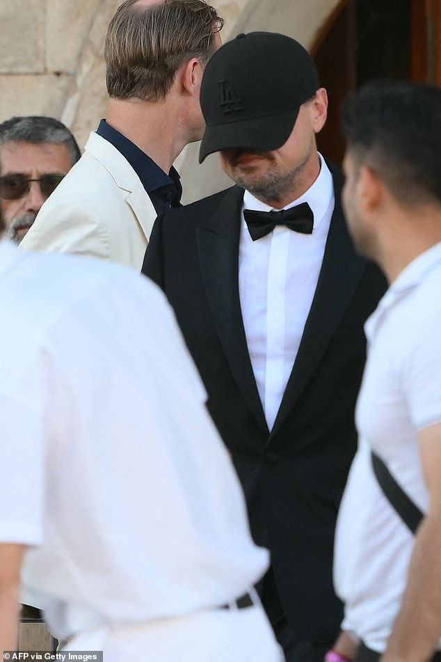 Despite being instantly recognizable as a Hollywood A-lister and clad in a tux for the wedding, the slimmed-down star still tried to hide as his hat fell over his face - leading amused fans to compare him to a 'baby elephant hiding behind a tree'