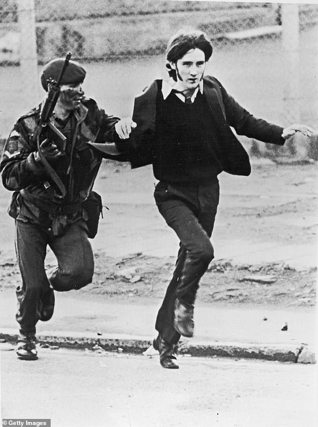 British soldiers were said to be constantly looking over their shoulders while based in Northern Ireland and that it was an 'extremely dangerous place'. Pictured is a British Paratrooper detaining a youth during riots on Bloody Sunday in 1972