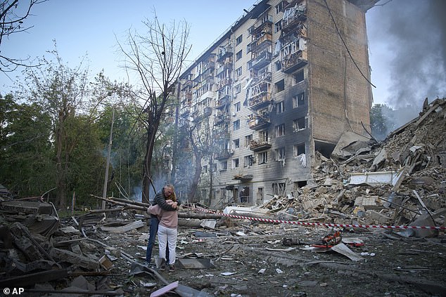 Residents react after a Russian missile hit a multi-storey apartment during Russia's combined missile and drone air attack in Kyiv, Ukraine, Tuesday, June 17, 2025