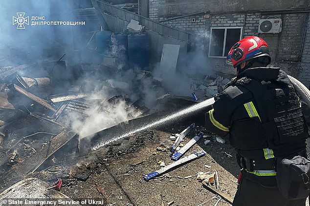 A firefighter extinguishing a blaze following a Russian missile strike in the eastern Ukrainian city of Dnipro on June 24 2025