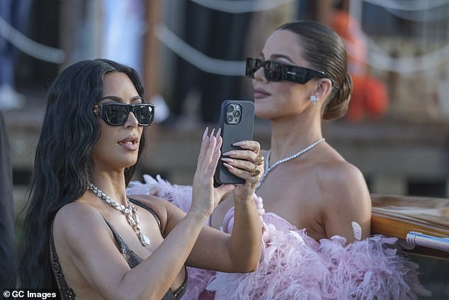 But despite being surrounded by A-listers and an opulent setting, Kim couldn¿t seem to stay off her phone