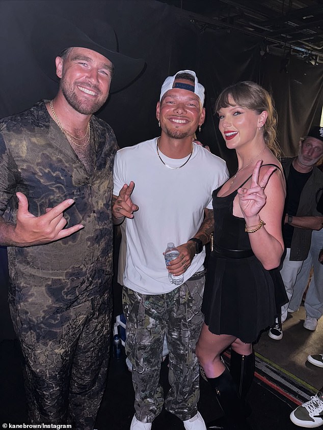 Kelce and Swift pose with country singer Kane Brown - who Taylor surprisingly joined on stage