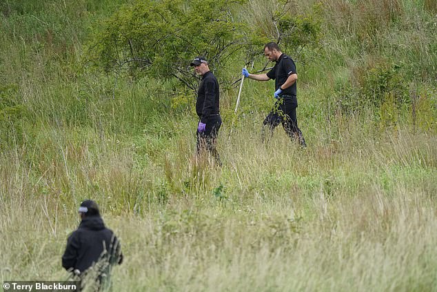 Police teams were also seen conducting searches on land on the riverbank