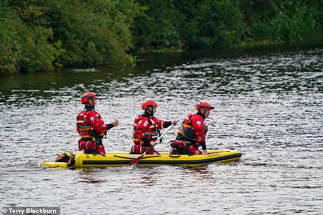 Emergency service teams searching the river on a boat earlier today