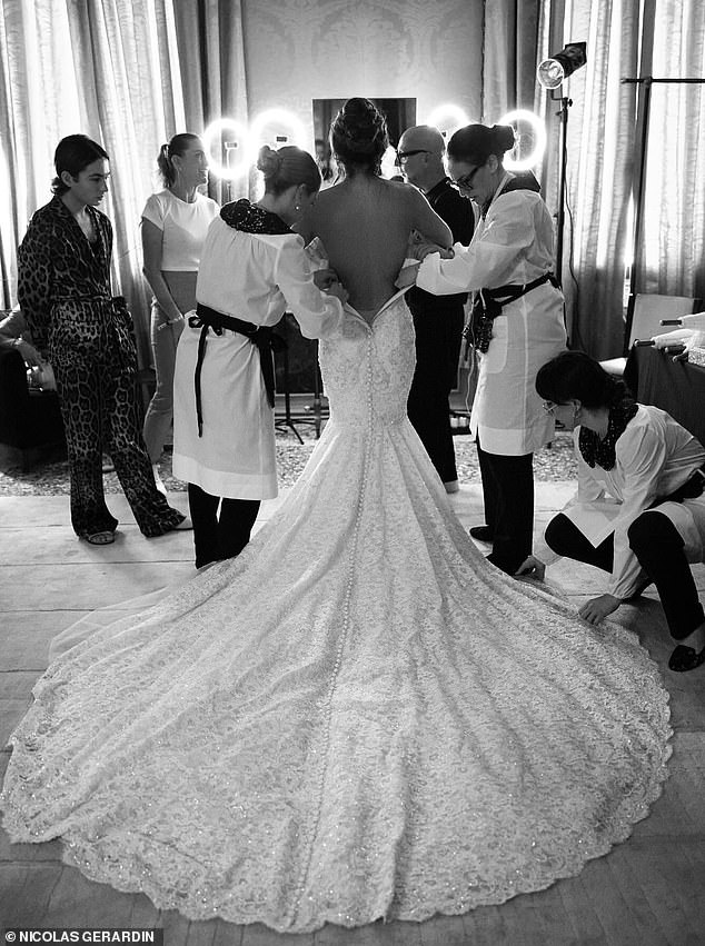 Sanchez's gown took 900 hours of atelier work - a total of 180 tiny, hand-finished buttons, each covered in silk chiffon, lined the neckline and torso before continuing down the length of the train (pictured)