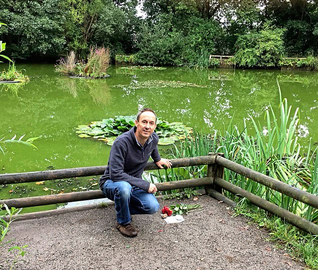 Nick, pictured in 2018, laying flowers at the pond where his twin’s body was found in 1998.
