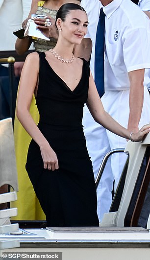 With her hair swept into an elegant bun, the Italian beauty was all smiles as she made her way to the wedding venue