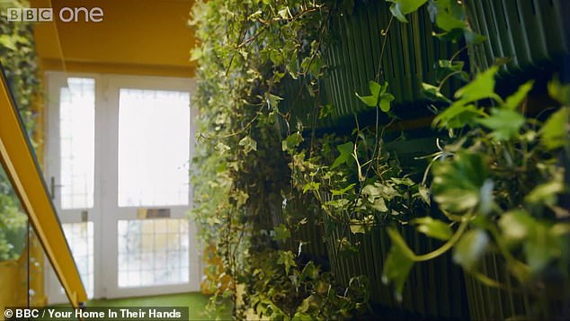 June batted plants out of the way as the pair looked at the fish tanks in the walls