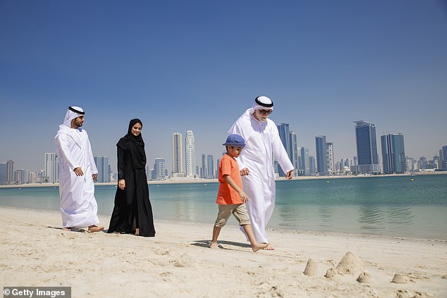 Pictured: A traditional three-generation Arabian family wearing traditional Emirati clothes
