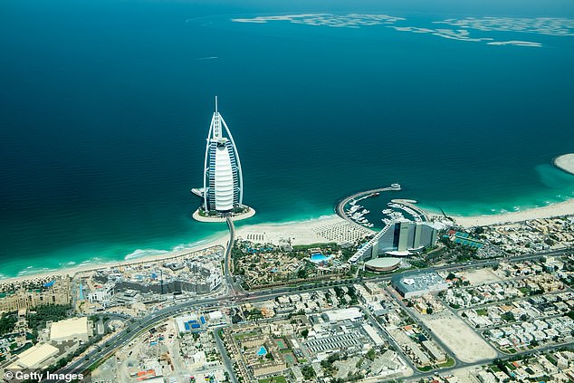 Pictured: A popular tourist area of Dubai with the Sheik Zayad Road and 'The Burj Al Arab' 7 star hotel and other hotels