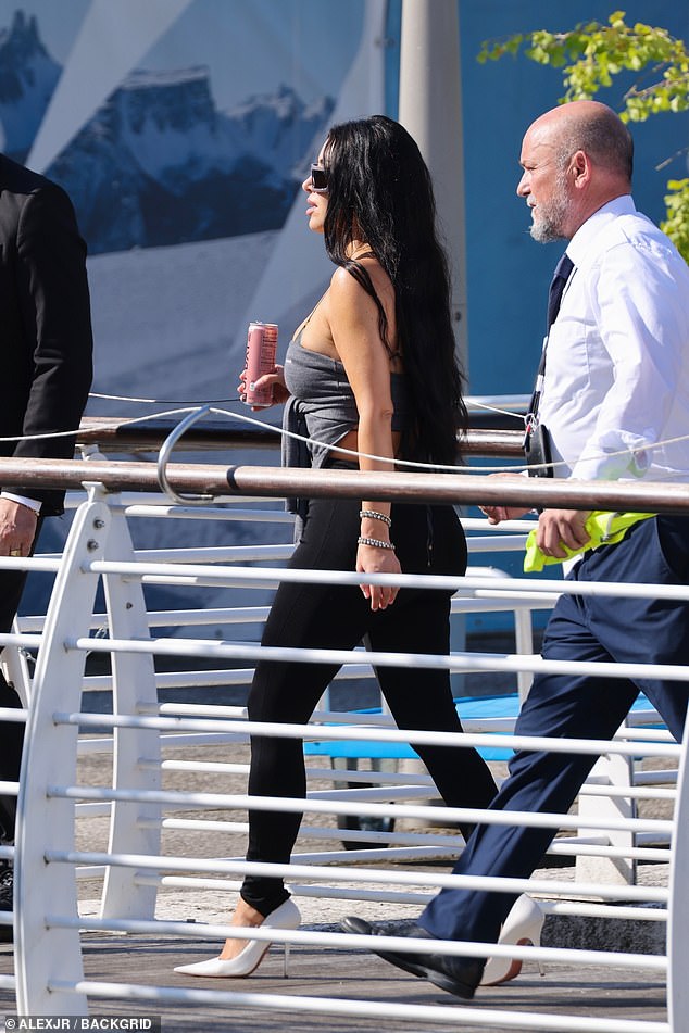 She donned black leggings and dark grey vest along with a pair of serene white high heels in the Italian sunshine
