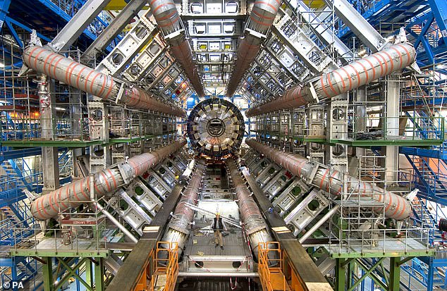 If the data from the Large Hadron Collider (pictured) is correct, the Higgs field is not in its most stable state. This means it could suddenly move into that new state like a domino toppling over