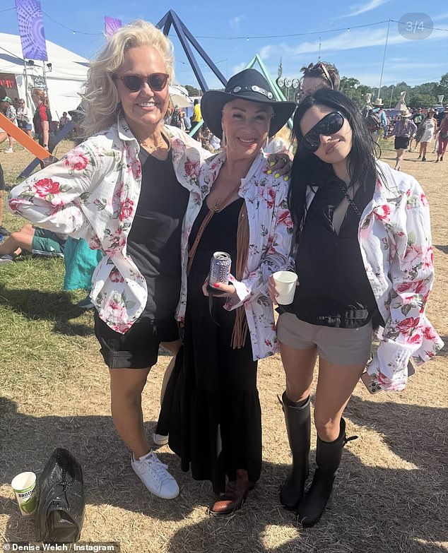 Denise, 67, modeled boho-glam in a rippling black dress, brown cowboy boots, and a black wide-cap hat studded with metal medallions