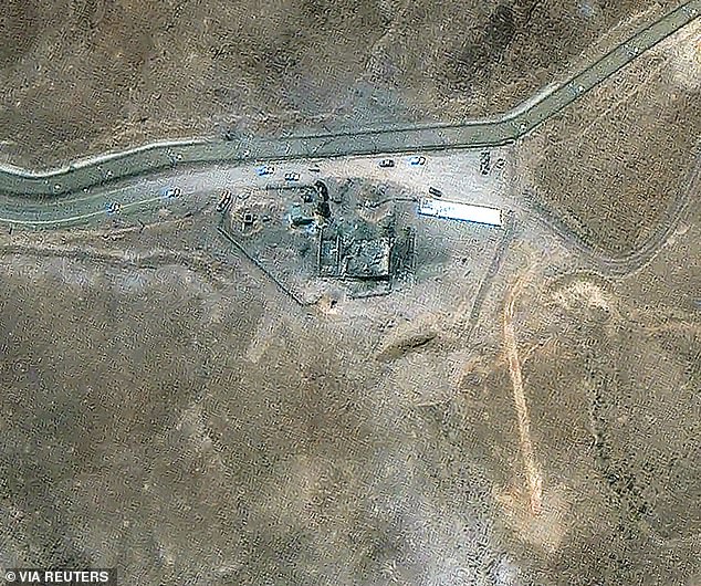 Vehicles can be seen near a damage site at the Fordow nuclear facility