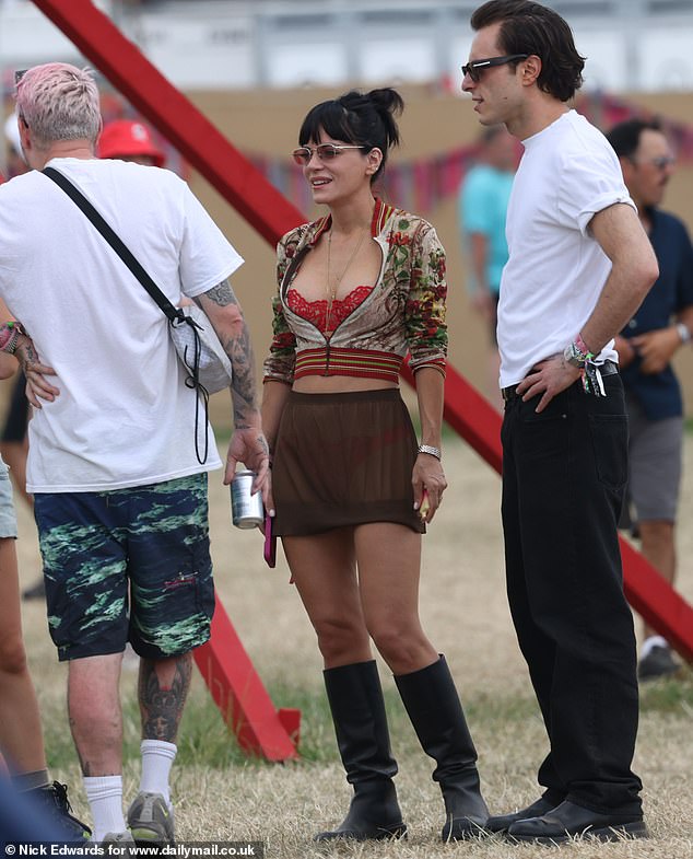 She swapped her shades for silver metal frames, carried a matching red padded bag, and completed the look with chunky black boots