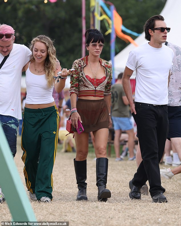 Lily Allen walks through Glastonbury alongside fashion designer Marco Capaldo