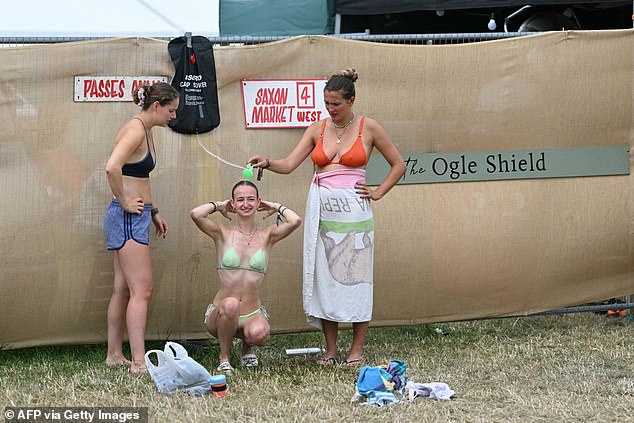 Festivalgoers take showers as they try and stay hygienic on the fourth day of the Glastonbury festival