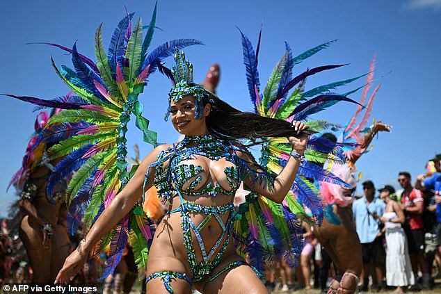 Performers from the Notting Hill Carnival dance in the Carhenge area on the fourth day of Glastonbury
